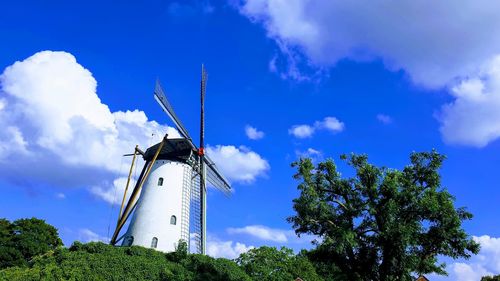 Low angle view of traditional windmill against sky