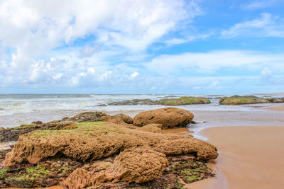 Rocks on beach against sky