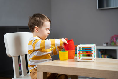 Portrait of cute boy eating food at home