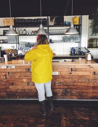 Full length of woman standing on wall