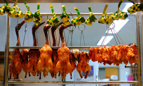 Close-up of roasting ducks for sale at market stall