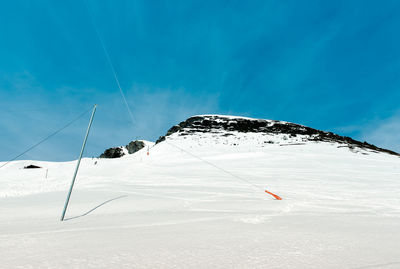 Snow covered mountain against blue sky