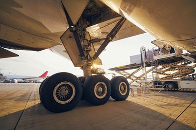 Preparation before flight. loading of cargo containers to airplane at airport.