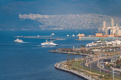 High angle view of cityscape by sea against sky