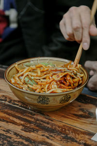 Midsection of person in bowl on table