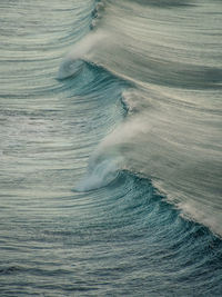 Vertical full frame shot of sea and blue wave 