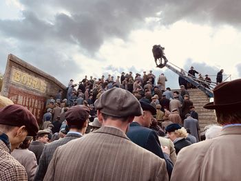 Rear view of people at festival against sky