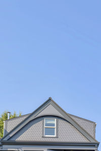 Low angle view of building against clear blue sky