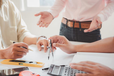 Midsection of business colleagues working at office