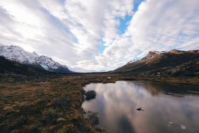 Scenic view of lake and mountains against sky