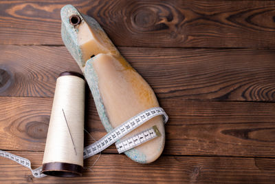 High angle view of old shoes on wooden table
