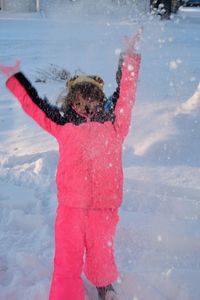 Woman with red umbrella on snow