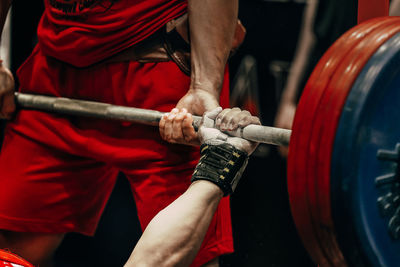 Cropped hand of man exercising in gym