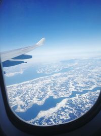 Aerial view of landscape seen through airplane window