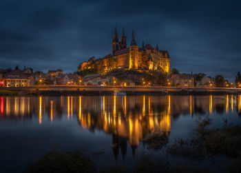 Reflection of illuminated buildings in lake