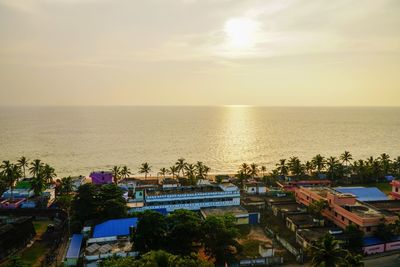 High angle view of sea against sky at sunset