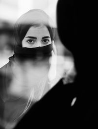 Portrait of woman looking through mirror