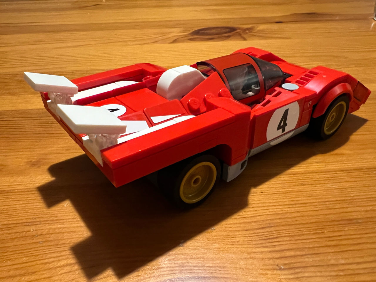 car, vehicle, mode of transportation, transportation, race car, motor vehicle, land vehicle, red, sports car, automobile, toy, model car, sports, wood, high angle view, toy car, speed, childhood, scale model, competition, open-wheel car, auto racing, sports race, driving