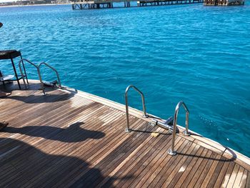 High angle view of chairs on swimming pool