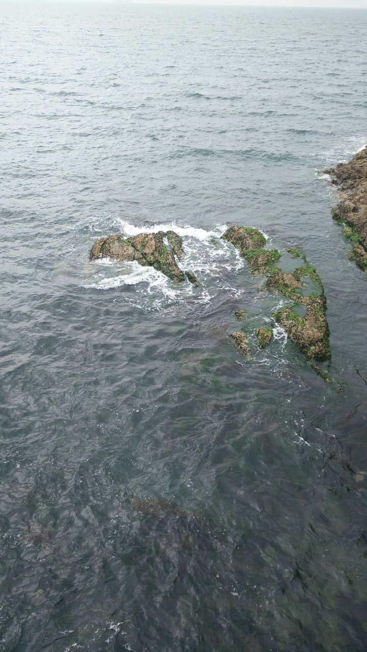 water, sea, tranquility, tranquil scene, beauty in nature, high angle view, scenics, rippled, nature, rock - object, idyllic, day, waterfront, no people, outdoors, coastline, remote, shore, non-urban scene, seascape