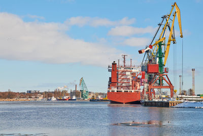 Moored cargo ships and harbor cranes in port. seaport, cargo container yard, container ship terminal