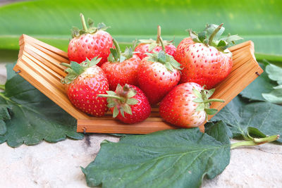 Close-up of strawberries on cutting board outdoors