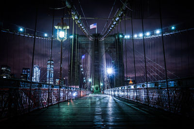 Illuminated bridge at night