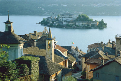 Panoramic view of city by sea against sky