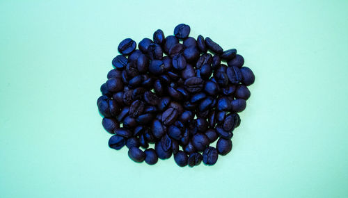 High angle view of coffee beans against blue background