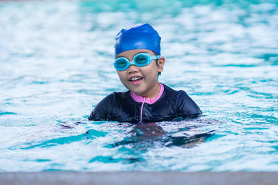 Portrait of boy swimming in pool