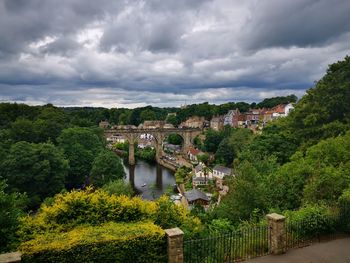 Knaresborough viaduct  over river amidst buildings against sky