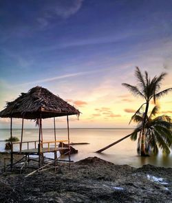 Lifeguard hut on beach during sunset