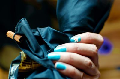 Cropped hand of woman holding fabric