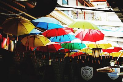 Multi colored flags hanging against sky