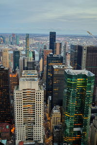 Aerial view of modern buildings in city against sky