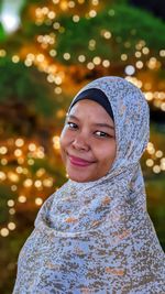 Portrait of young woman standing outdoors