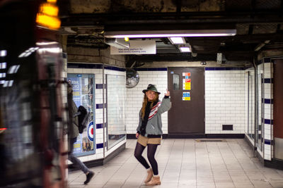 Full length of woman walking in subway