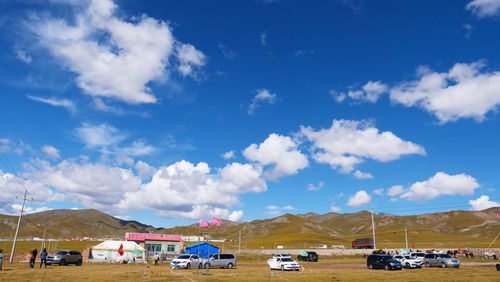 Cars on land against blue sky