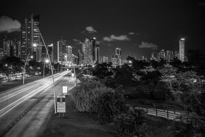 High angle view of light trails on street against buildings at night