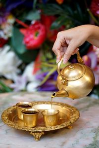 Close-up of hand pouring candle