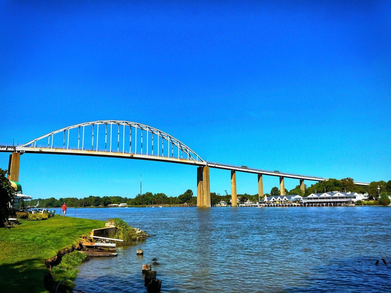 VIEW OF BRIDGE OVER RIVER AGAINST BLUE SKY