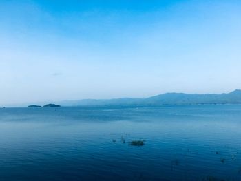 Scenic view of sea against blue sky