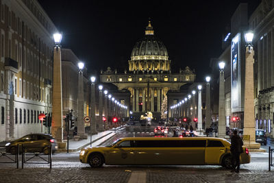 View of illuminated street and buildings at night