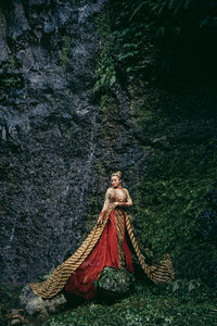 Woman in basket with trees in background