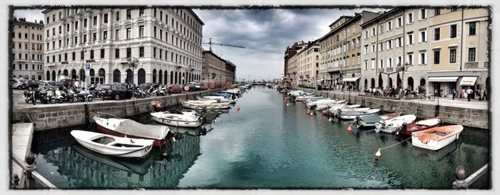 Boats in canal along buildings