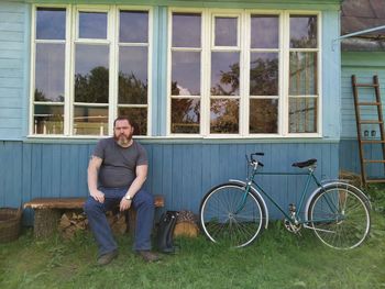 Portrait of man with bicycle against plants