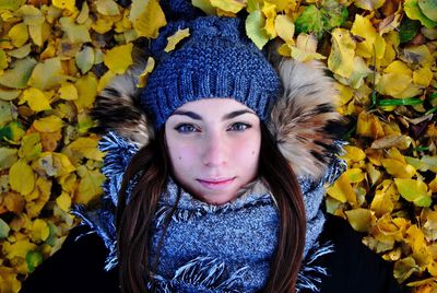 Portrait of beautiful young woman in autumn leaves