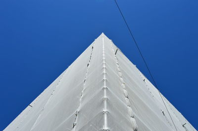 Low angle view of modern building against clear blue sky