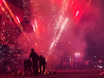 People against firework display at night