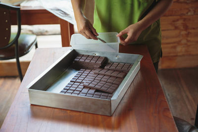 Midsection of woman working on table